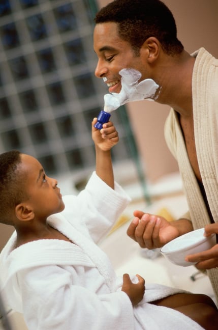 Son helping dad shave