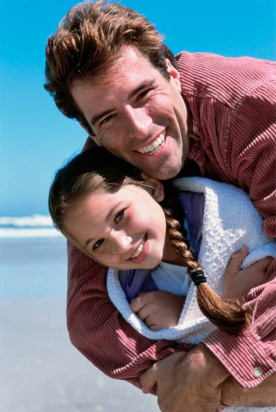 Happy father and daughter on beach