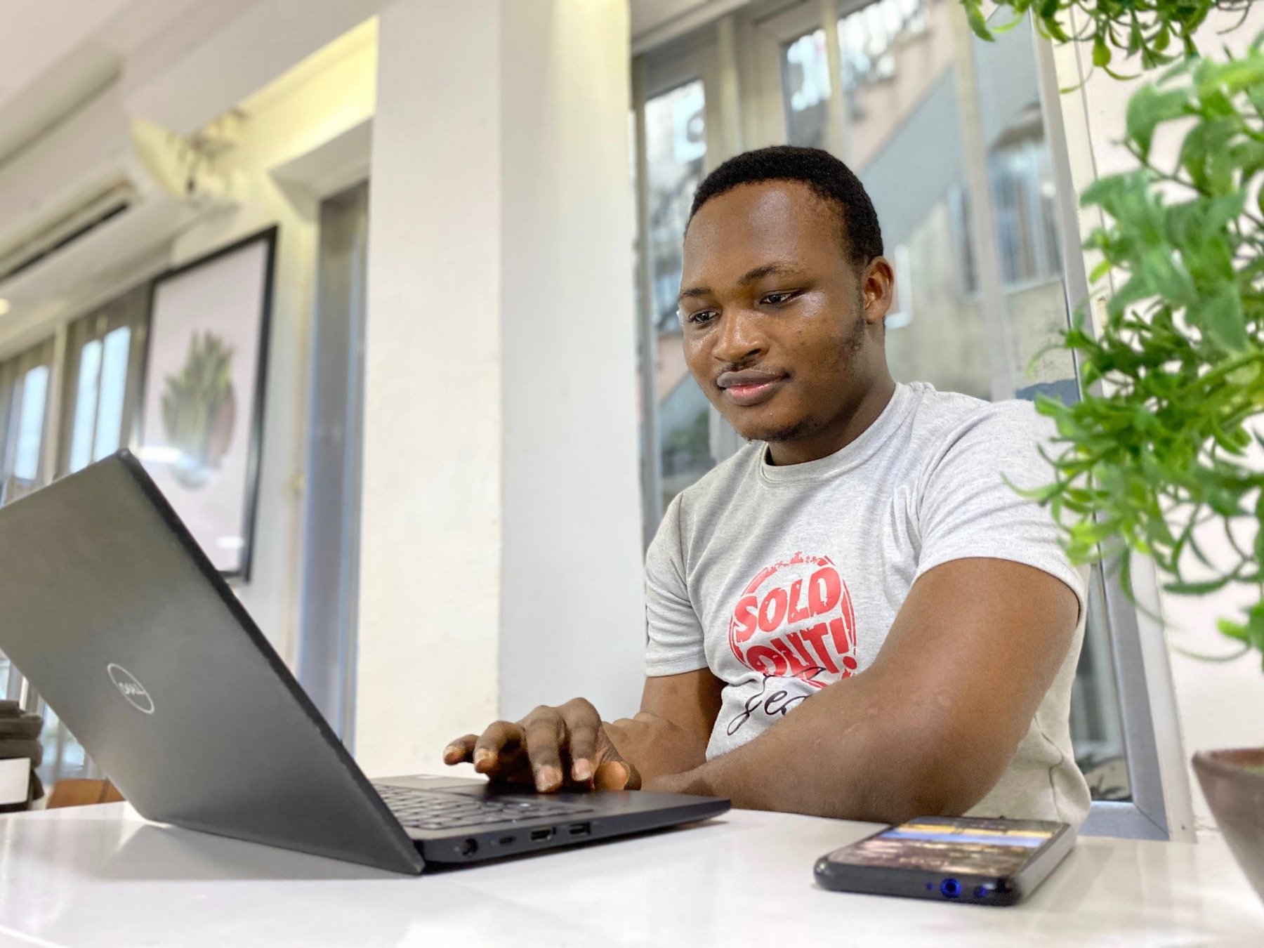 A man does research on his computer while sitting at his desk.