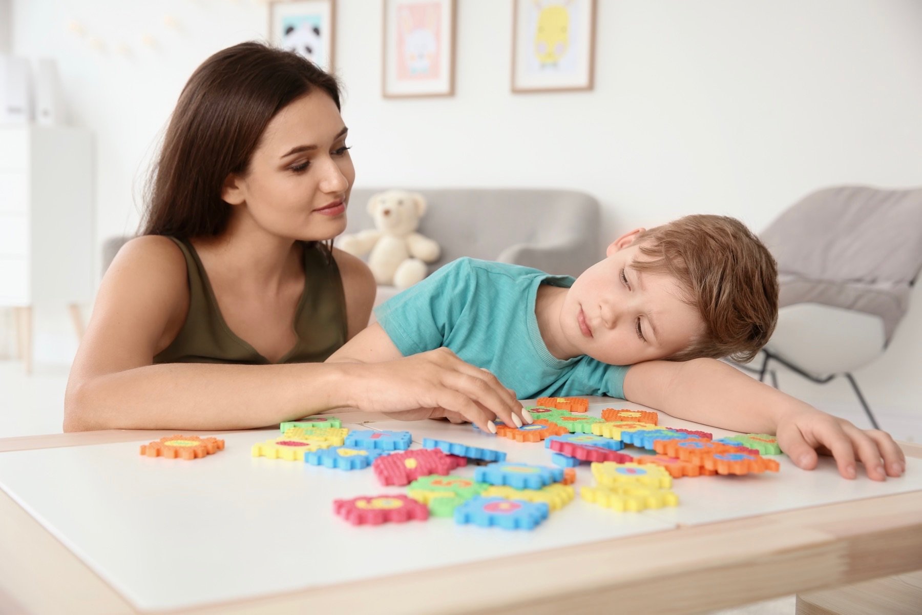 Mom playing with sensory toys with her son. 