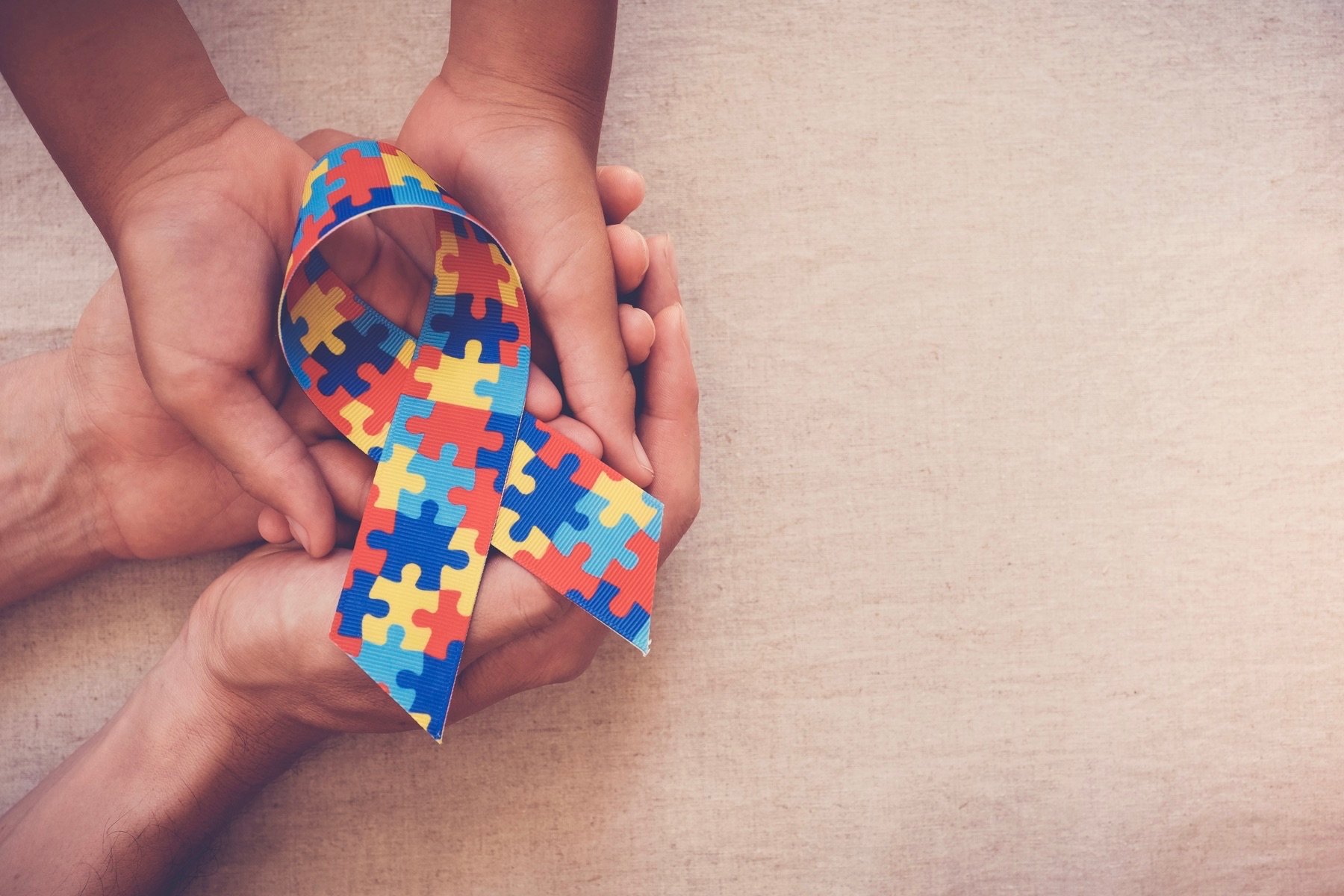 Hands holding autism awareness ribbon