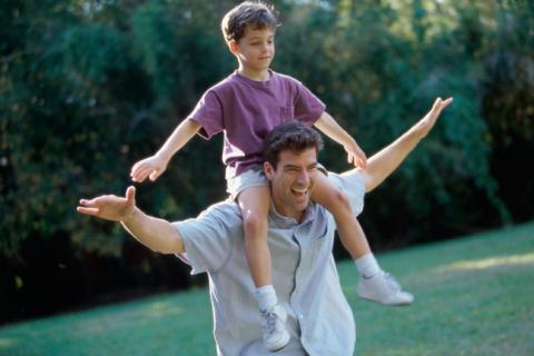 Father carrying son on shoulders