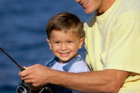 Father teaching son to fish.