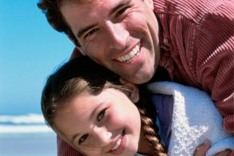 Happy father and daughter on beach