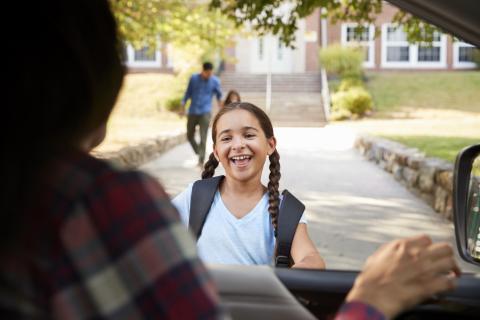 Mother picks up her daughter from school.