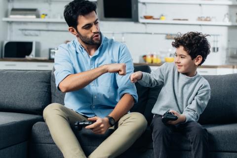 Dad fist bumping son. 