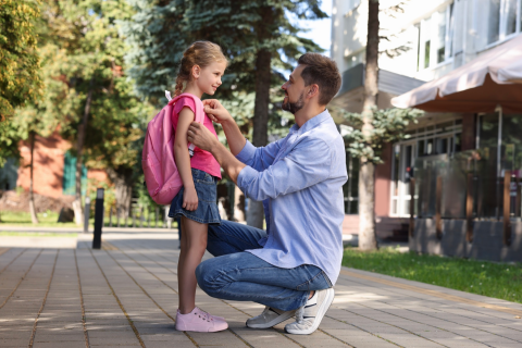 Man dropping his daughter off at school.