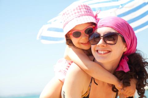 Woman and daughter at beach. 