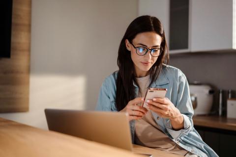 Woman on laptop and phone