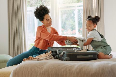 Mom helping daughter pack. 