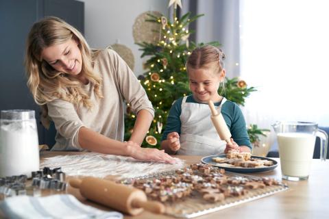 Mom and daughter making cookies.