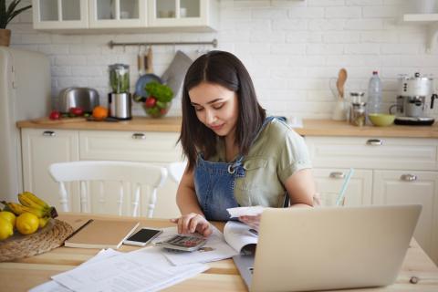 Woman on laptop doing taxes.