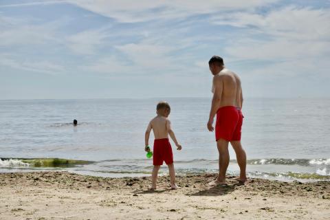 Dad and son on beach. 