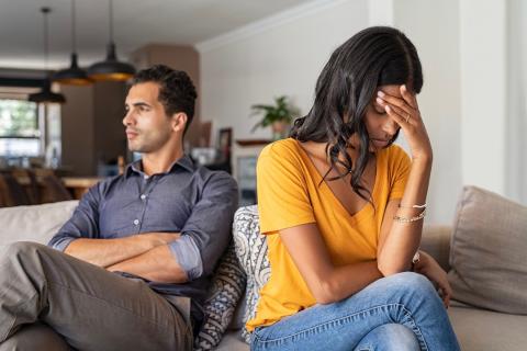 Man and woman arguing in living room.