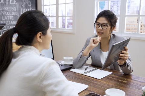 Lawyer showing client her custody schedule on a tablet.