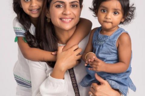 Mom and two daughters posing for family photo