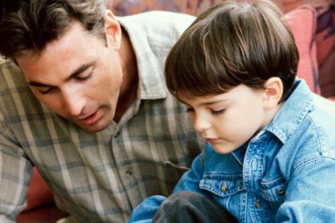 Dad teaching son how to tie shoes