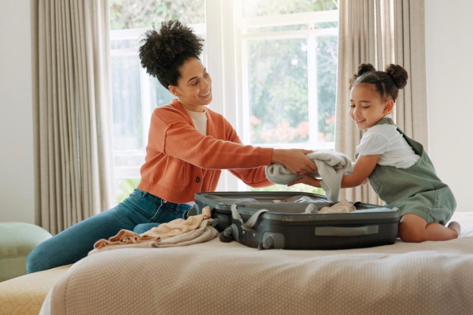 Mom helping daughter pack.