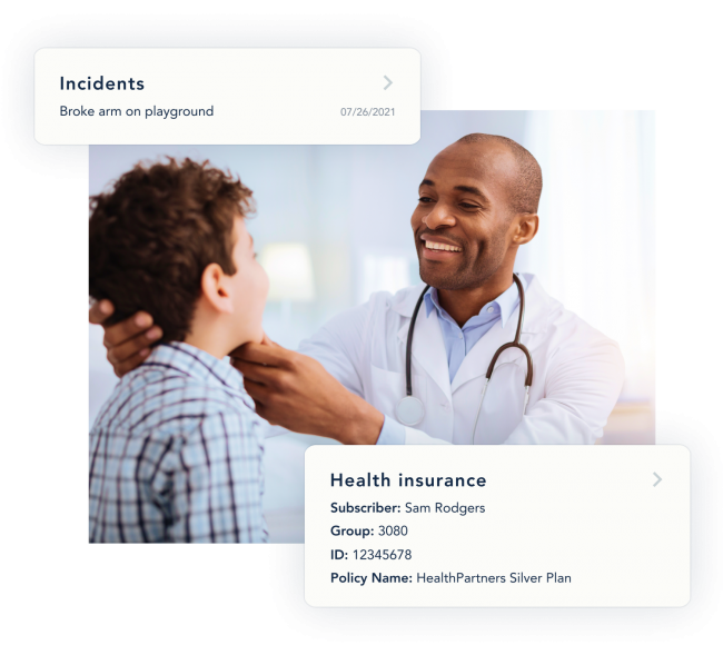 A doctor smiles as he examines a young patient.