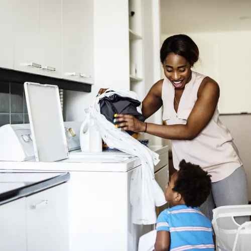 Mother and son doing laundry together