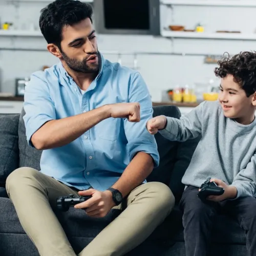 Dad fist bumping son. 