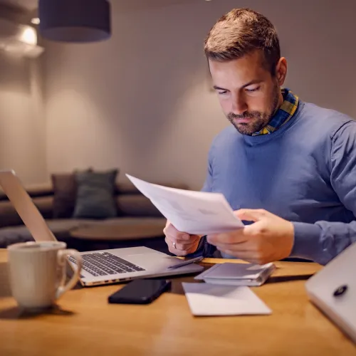 A man doing paperwork at home
