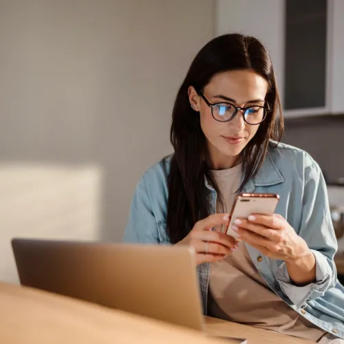 Woman on laptop and phone
