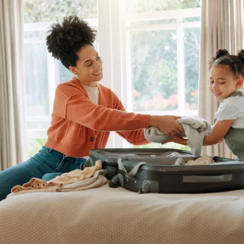 Mom helping daughter pack. 