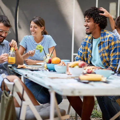 Friends sitting and eating healthy food.
