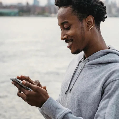 Man smiling at his phone.