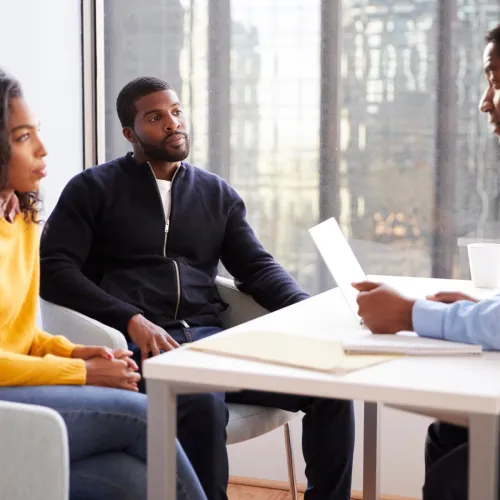 Man and woman meeting with a professional.