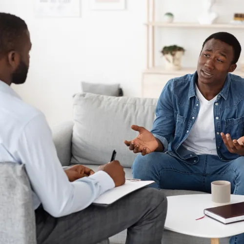 Man having a therapy session with a male therapist.