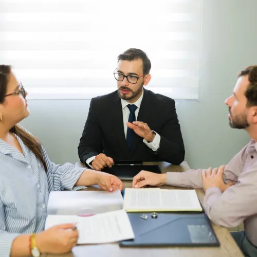 Man and woman meeting with an attorney. 