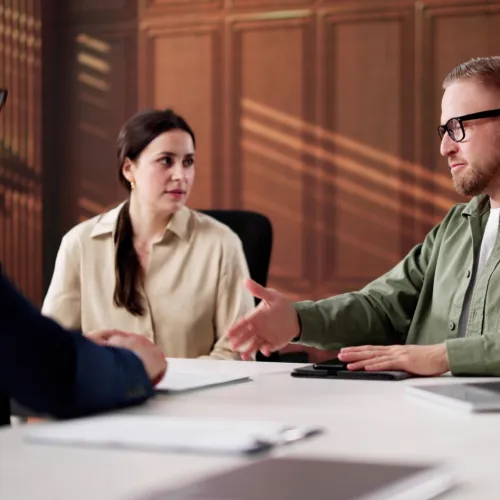 Man and woman meeting with mediator.