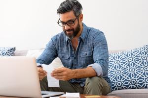 A father looks over the pricing for OurFamilyWizard on his computer