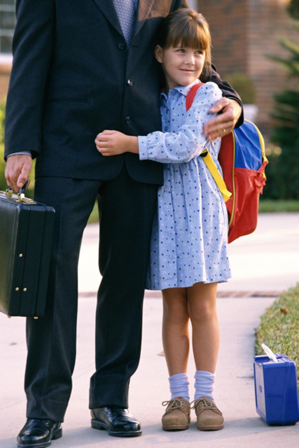 Daughter hugging dad before going off to school