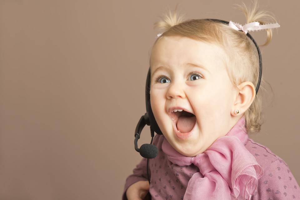 Young girl wearing headset, yelling gleefully 