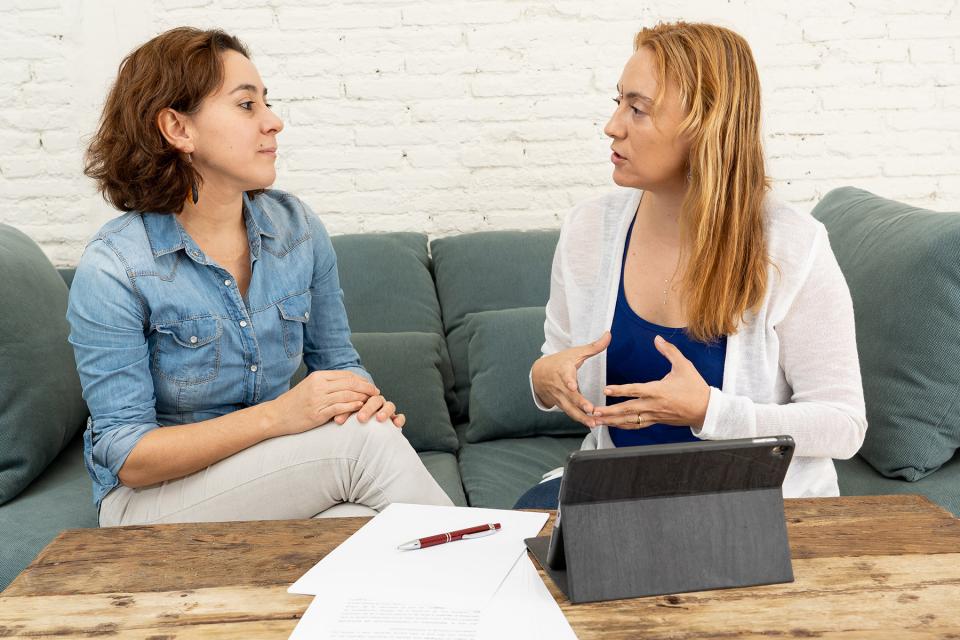 Guardian ad litem speaks with a parent in her home.