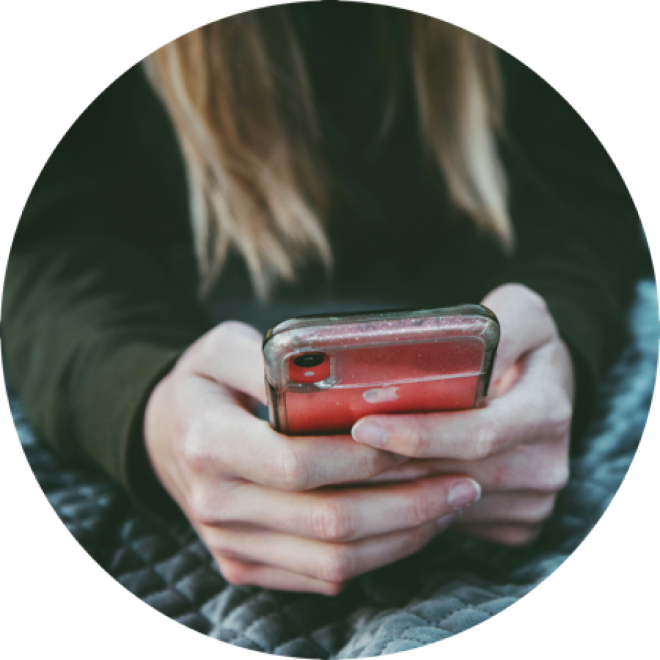 Woman's hands holding a smartphone.