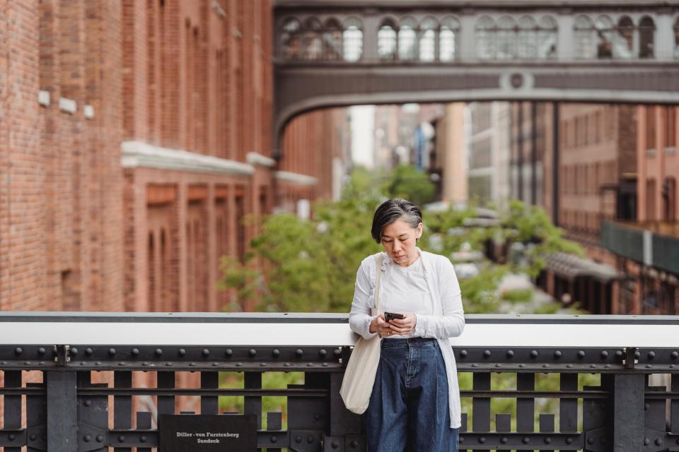 woman outside on bridge on phone