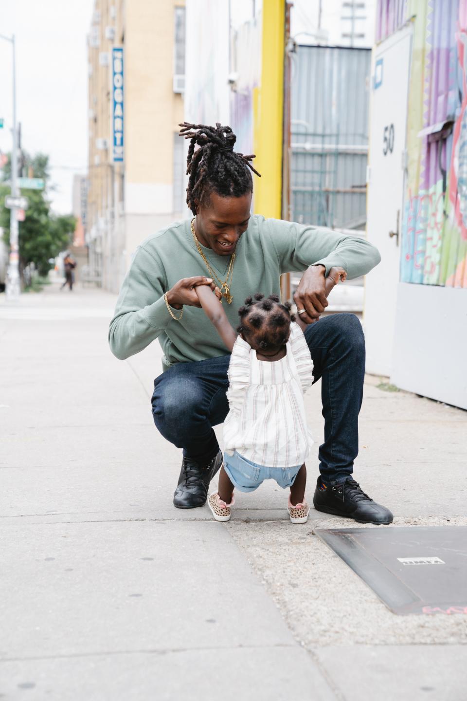 child being supervised outside on sidewalk