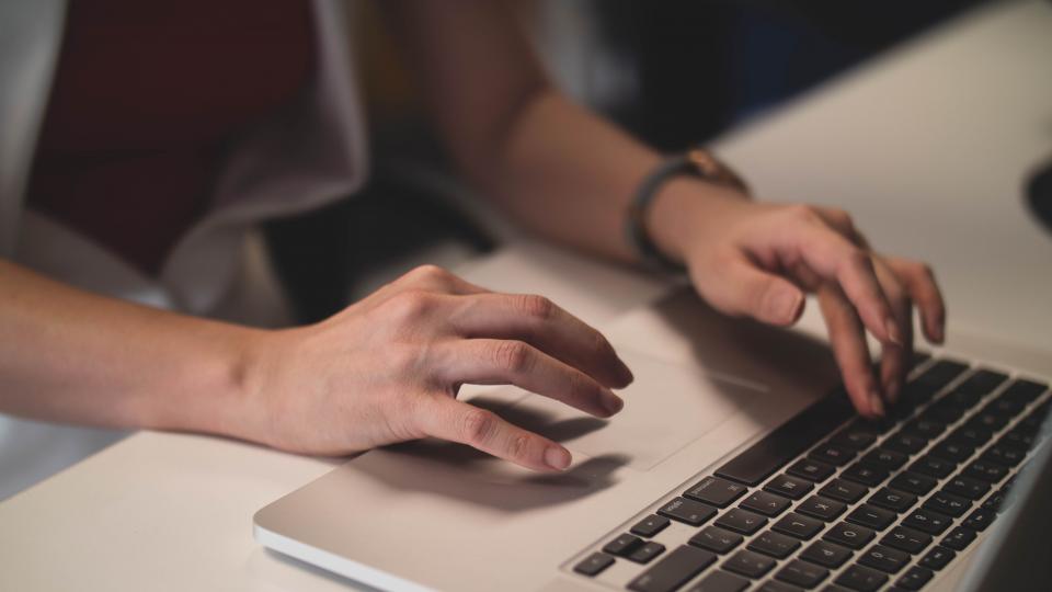 woman on laptop writing a report