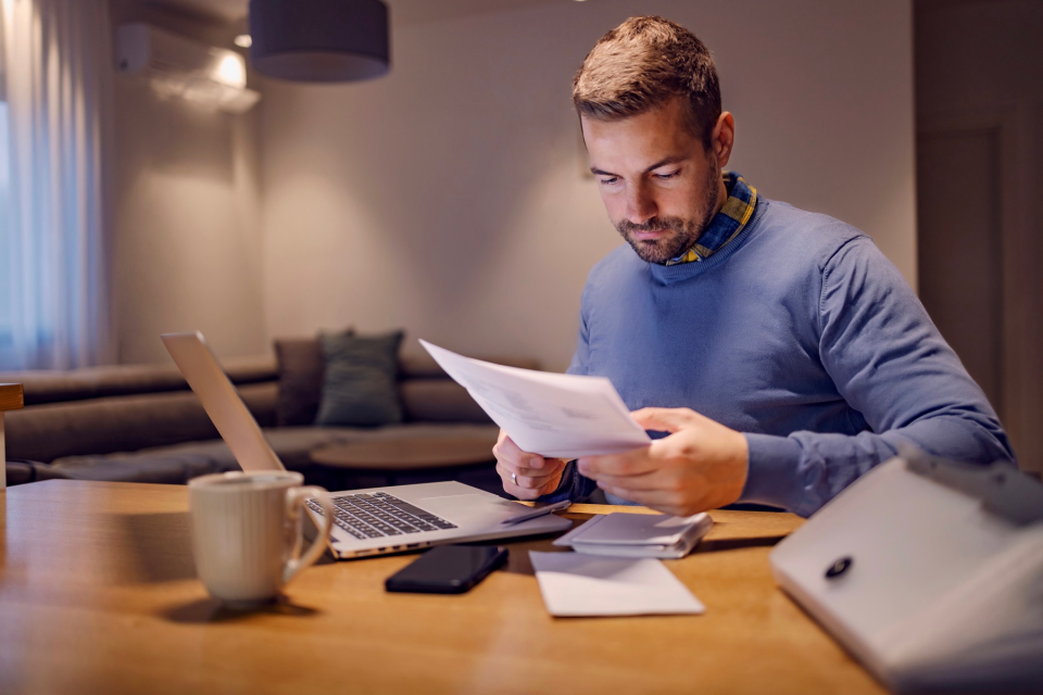 A man doing paperwork at home