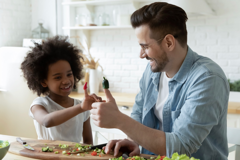 Dad and daughter making dinner. 