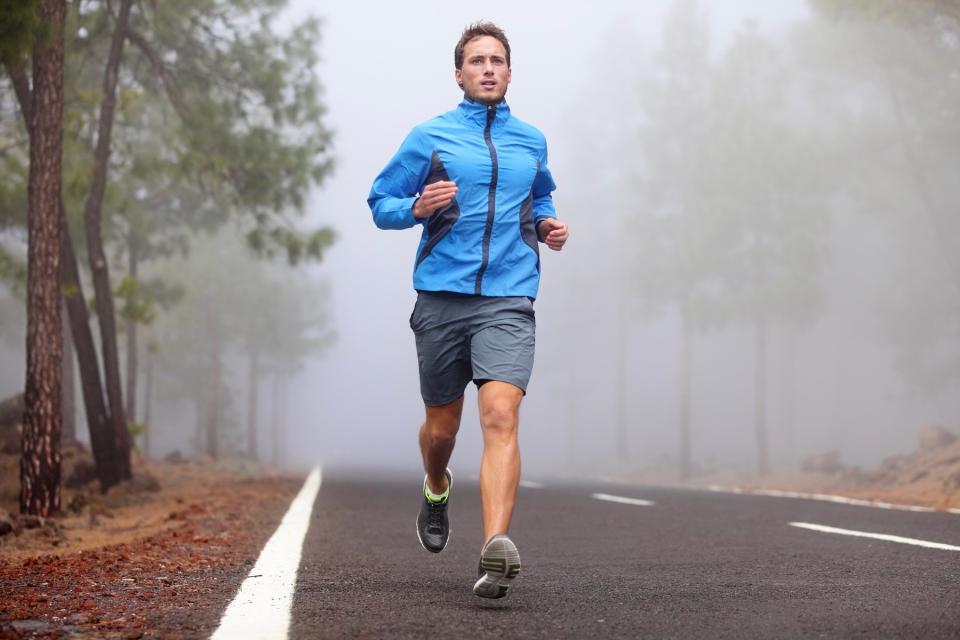 Man running on road.