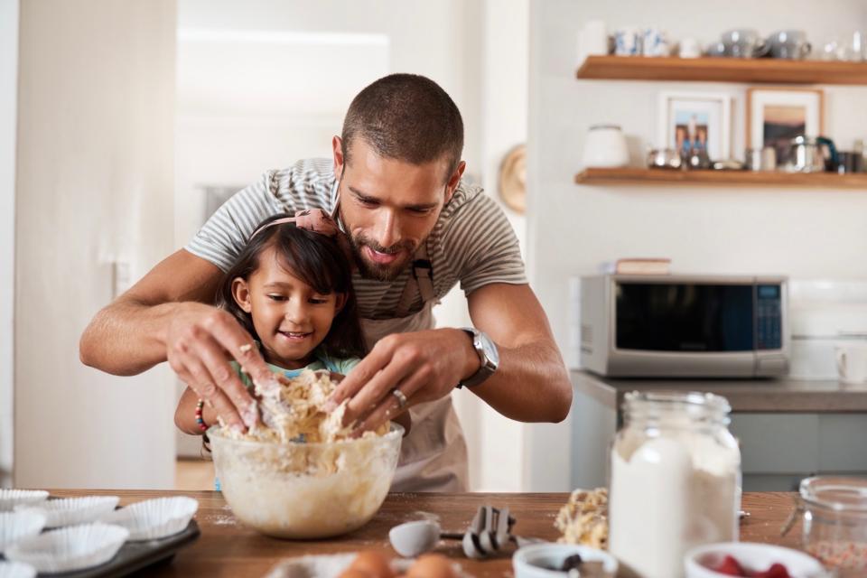 Dad cooking with daughter. 