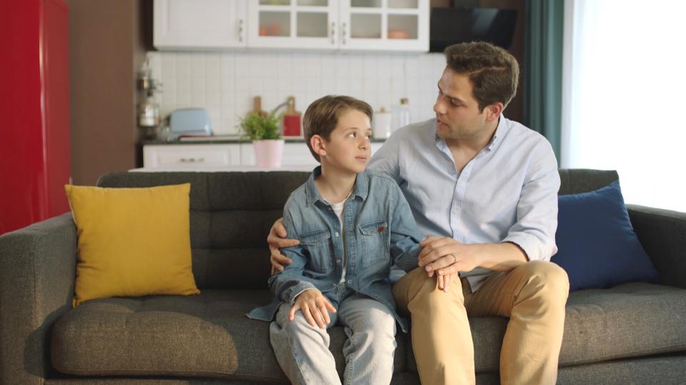 Man comforting his son. 