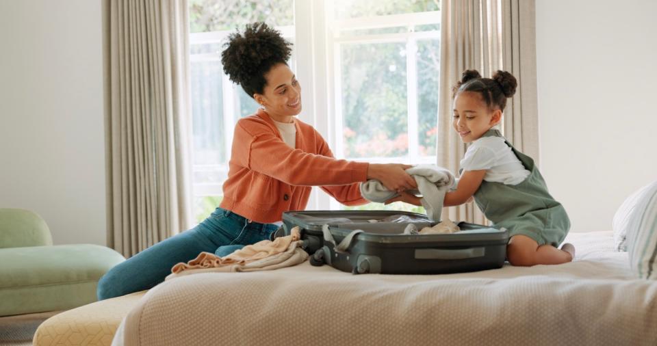 Mom helping daughter pack. 