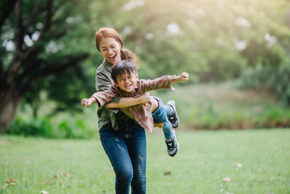 Mom and son playing outside. 