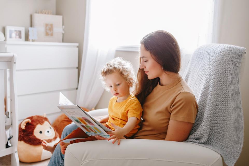 Mom reading book to sick child. 